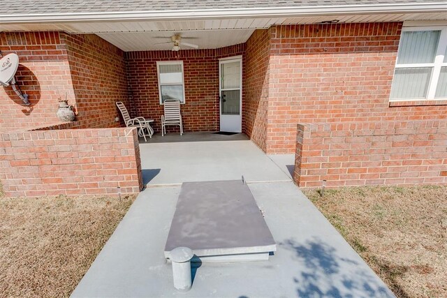 doorway to property with ceiling fan and a patio