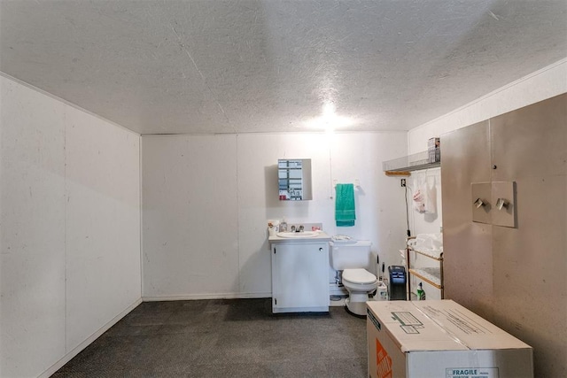 interior space with sink, dark carpet, and a textured ceiling