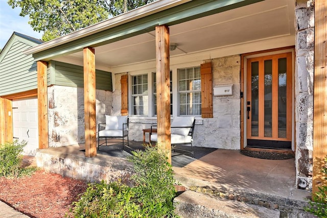 entrance to property featuring a porch and a garage