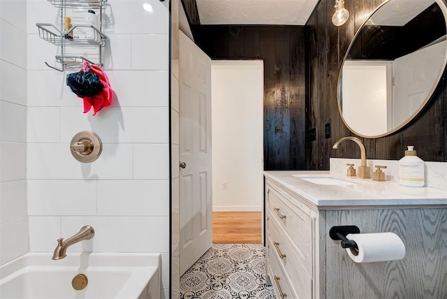 bathroom with vanity, tile patterned floors, and a bathtub