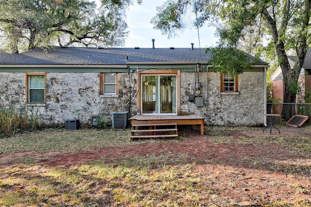 back of house featuring cooling unit and a deck