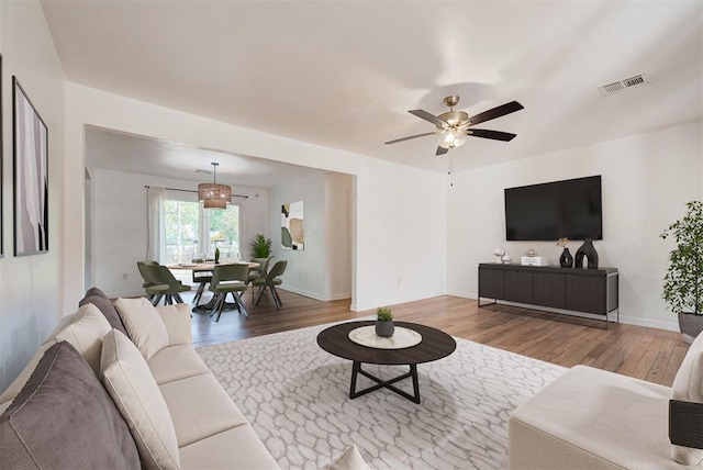 living room with hardwood / wood-style flooring and ceiling fan