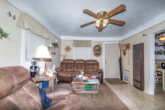 tiled living room featuring a textured ceiling and ceiling fan