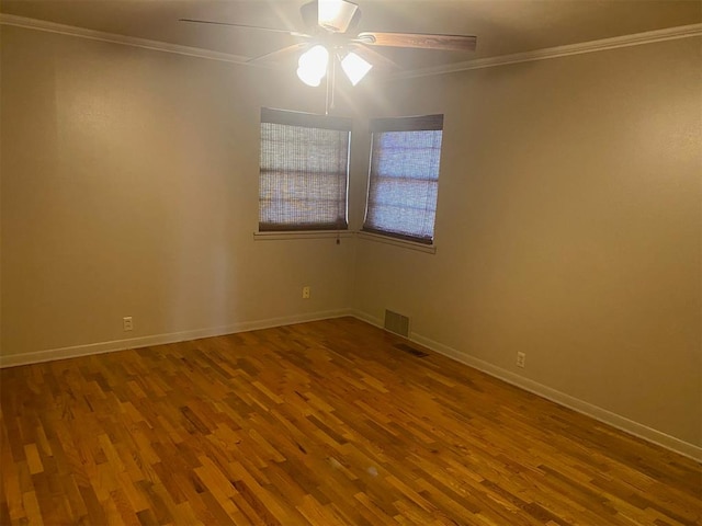 empty room featuring hardwood / wood-style floors, ceiling fan, and ornamental molding