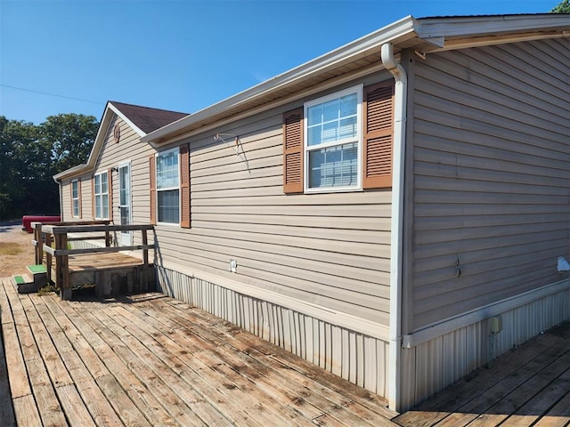 view of property exterior featuring a wooden deck