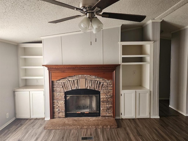 details featuring hardwood / wood-style floors, crown molding, ceiling fan, built in shelves, and a textured ceiling