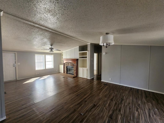 unfurnished living room featuring a brick fireplace, a textured ceiling, and hardwood / wood-style flooring