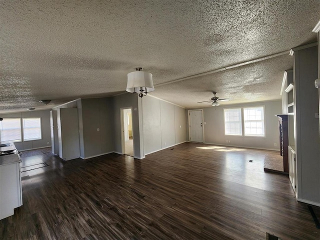 unfurnished living room featuring ceiling fan, dark hardwood / wood-style flooring, and a textured ceiling