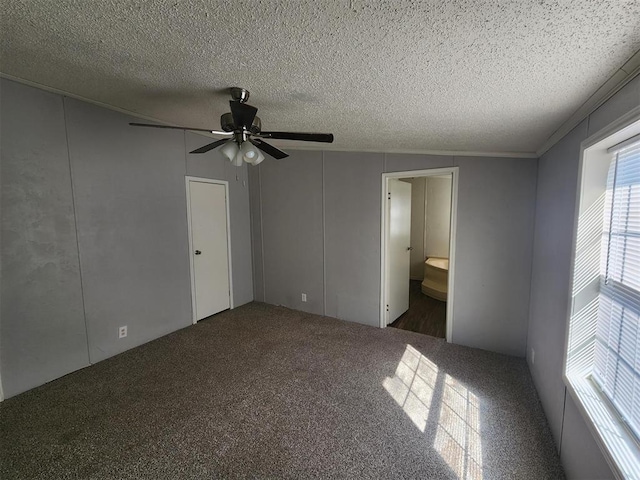 unfurnished bedroom with connected bathroom, ceiling fan, and a textured ceiling