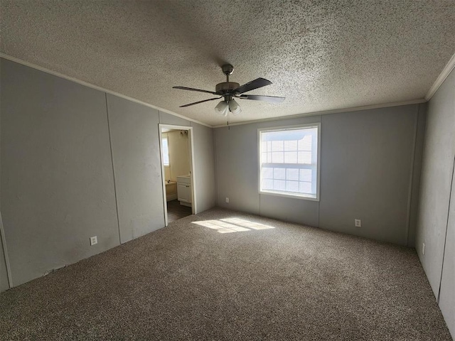 unfurnished bedroom with carpet flooring, a textured ceiling, ensuite bathroom, and ceiling fan