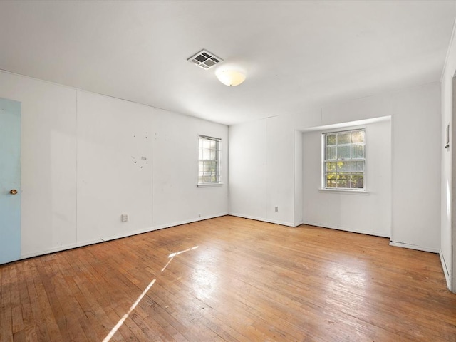 empty room featuring a healthy amount of sunlight and light wood-type flooring