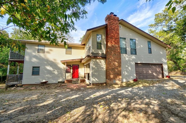 rear view of house featuring a garage