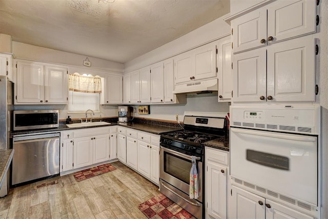 kitchen featuring white cabinets, light hardwood / wood-style floors, sink, and stainless steel appliances