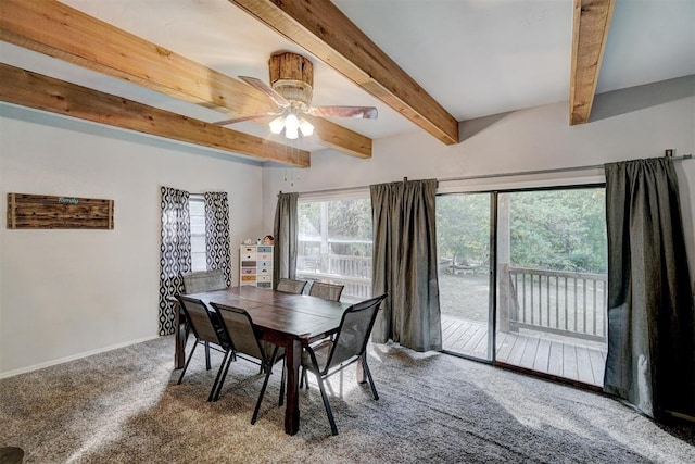 carpeted dining space with beamed ceiling and ceiling fan