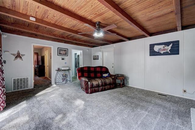 living room featuring beamed ceiling, carpet floors, and wooden ceiling