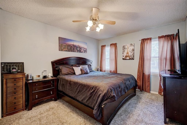 carpeted bedroom with ceiling fan, a textured ceiling, and multiple windows