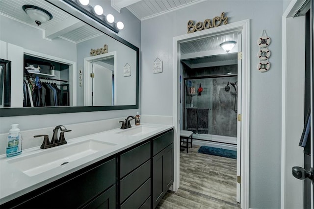 bathroom featuring hardwood / wood-style flooring, vanity, and an enclosed shower