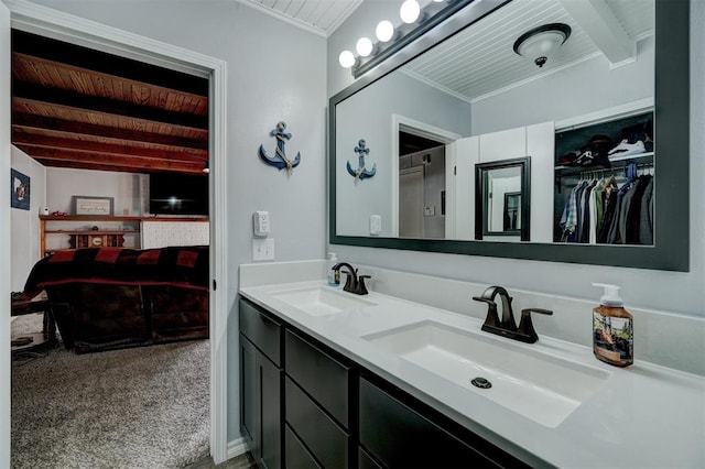 bathroom featuring beamed ceiling, vanity, and crown molding