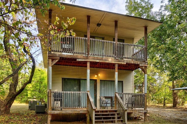 rear view of house with covered porch and central air condition unit