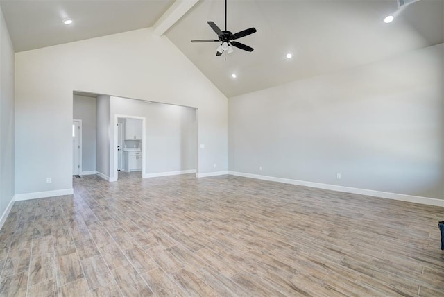 empty room featuring beamed ceiling, light hardwood / wood-style floors, high vaulted ceiling, and ceiling fan