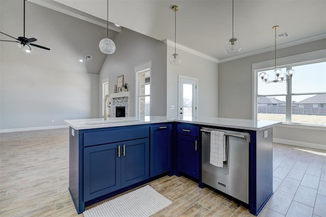 kitchen featuring sink, plenty of natural light, and a center island with sink