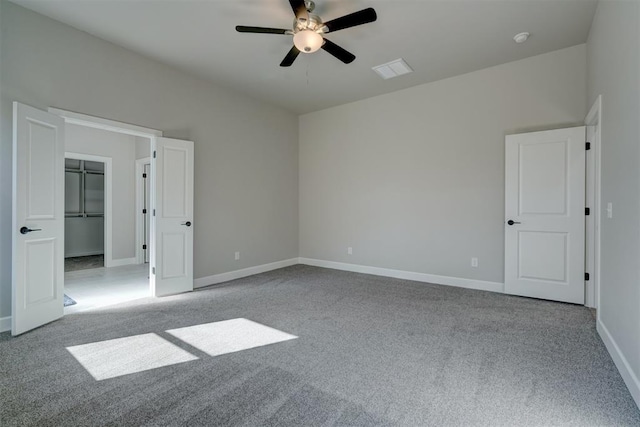 unfurnished bedroom featuring ceiling fan, a closet, and light carpet