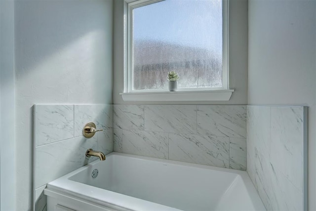 bathroom with a tub to relax in