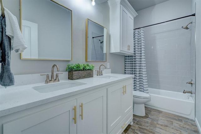 full bathroom with shower / bathtub combination with curtain, hardwood / wood-style floors, vanity, and toilet