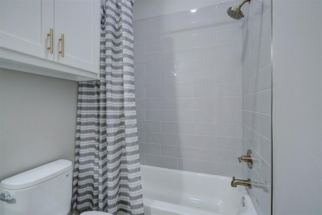 bathroom featuring shower / bath combo with shower curtain and toilet