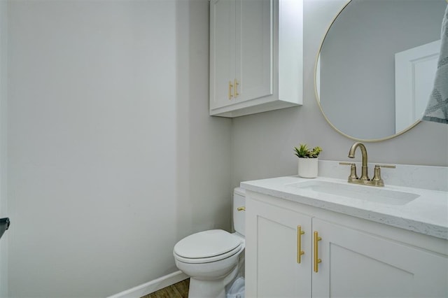 bathroom featuring hardwood / wood-style flooring, vanity, and toilet