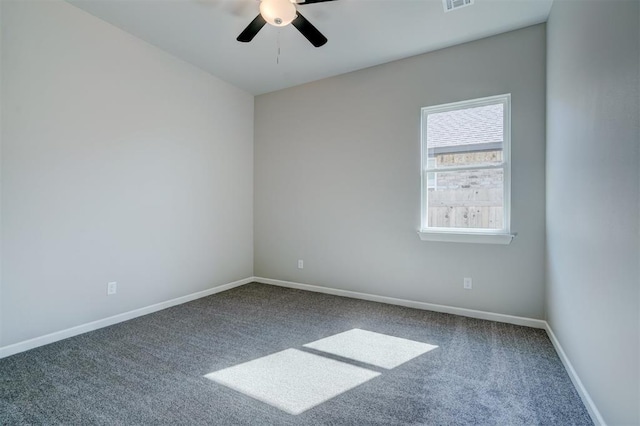 carpeted spare room featuring ceiling fan