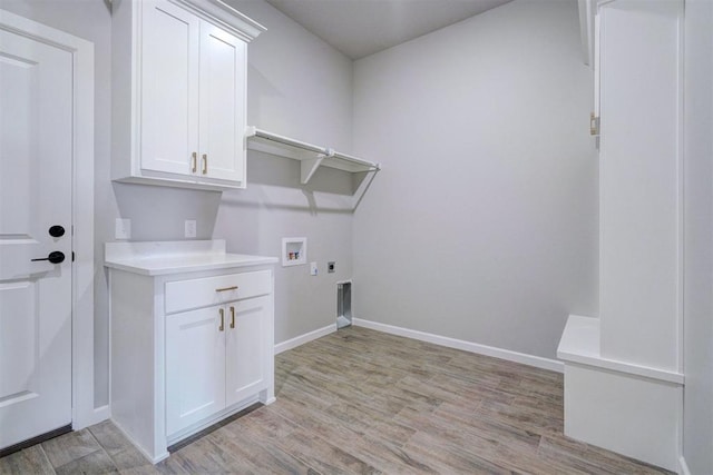 laundry room featuring hookup for an electric dryer, washer hookup, cabinets, and light hardwood / wood-style flooring