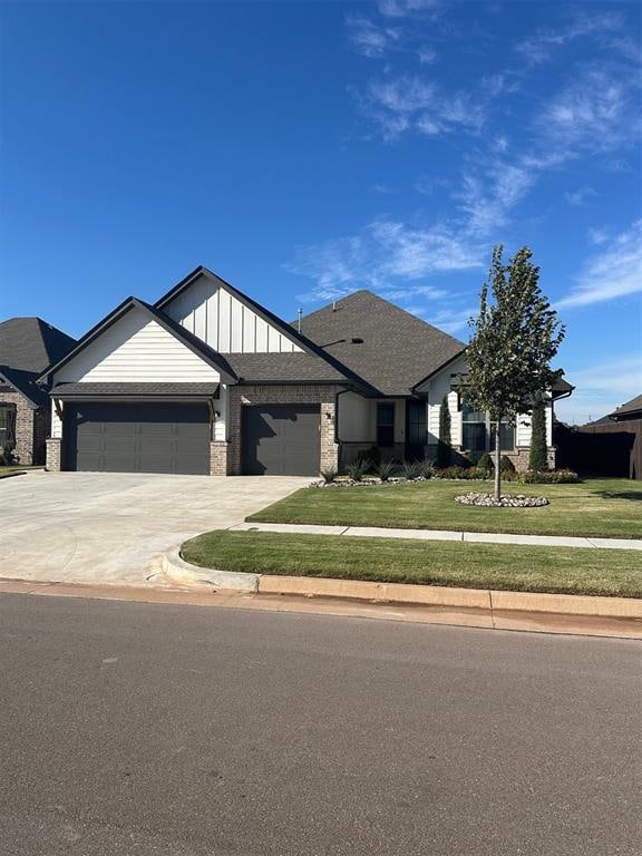 view of front of property with a front lawn and a garage