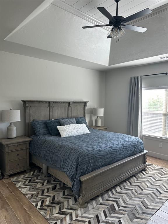 bedroom with ceiling fan and hardwood / wood-style floors