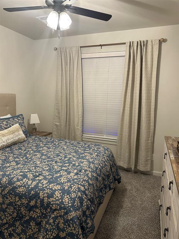 carpeted bedroom with ceiling fan