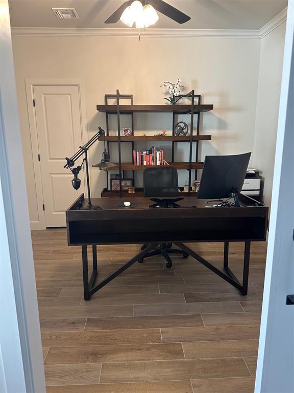 office area featuring ceiling fan, hardwood / wood-style floors, and ornamental molding