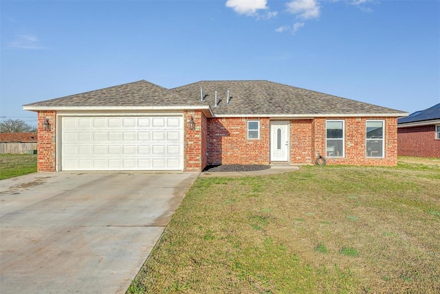 ranch-style house featuring a garage and a front lawn