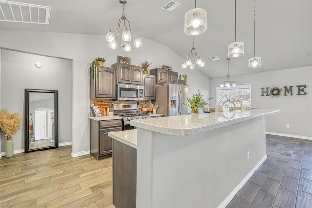 kitchen featuring stainless steel appliances, light hardwood / wood-style flooring, an island with sink, lofted ceiling, and dark brown cabinets