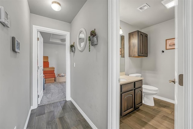 bathroom with vanity, hardwood / wood-style flooring, and toilet