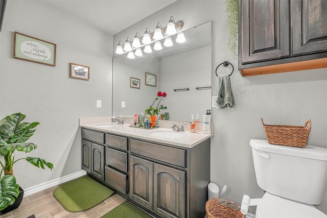 bathroom with wood-type flooring, vanity, and toilet