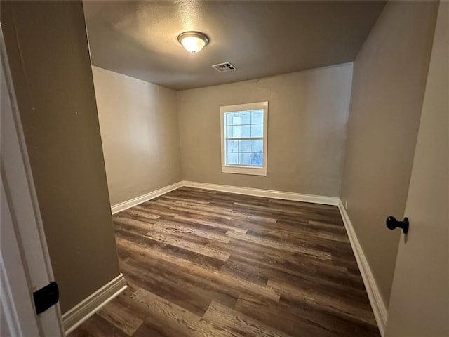 empty room with dark hardwood / wood-style floors