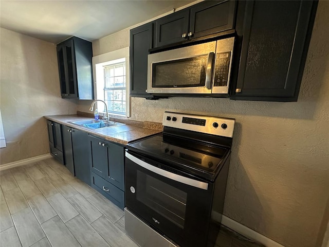 kitchen featuring stainless steel appliances, light hardwood / wood-style floors, and sink