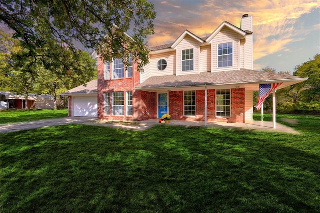 view of front of house featuring a lawn and a garage