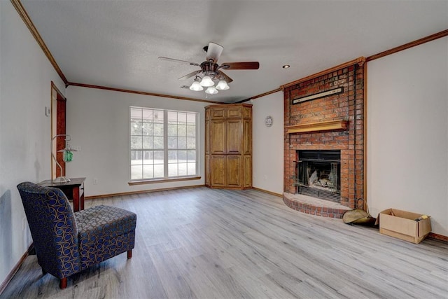 living area with light wood-type flooring, a brick fireplace, ceiling fan, and ornamental molding