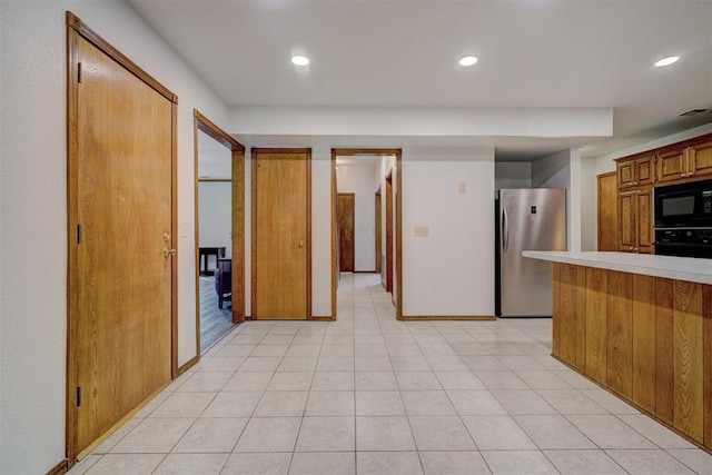 kitchen featuring black appliances and light wood-type flooring