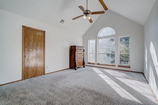 unfurnished bedroom featuring carpet flooring, ceiling fan, beamed ceiling, and high vaulted ceiling