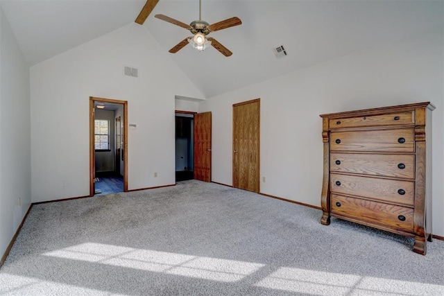 unfurnished bedroom featuring connected bathroom, ceiling fan, carpet floors, and high vaulted ceiling