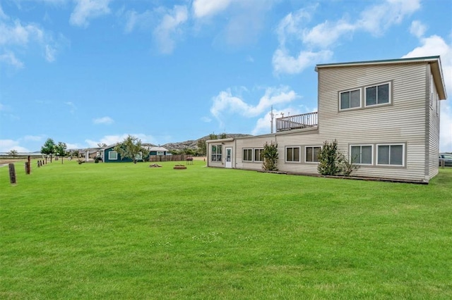 rear view of property featuring a yard