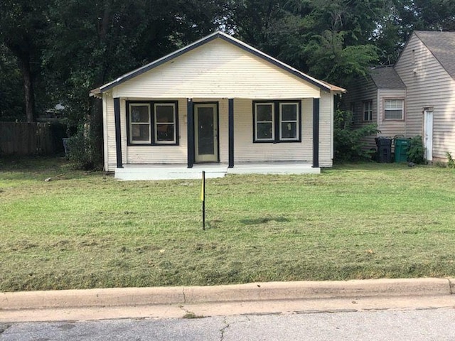 view of front of property with a porch and a front lawn