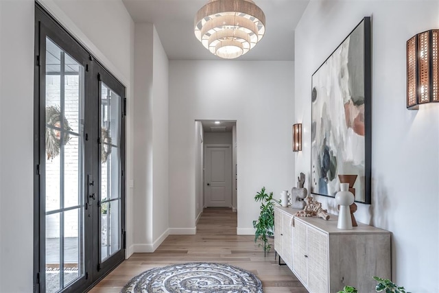 entrance foyer with light hardwood / wood-style floors and french doors